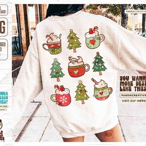 May include: A white sweatshirt featuring a festive design with Christmas trees and mugs of hot chocolate. The mugs are decorated with hearts, candy canes, and strawberries. The text "DIGITAL DOWNLOAD PNG DISTRESSED & SOLID PNGS" is visible.