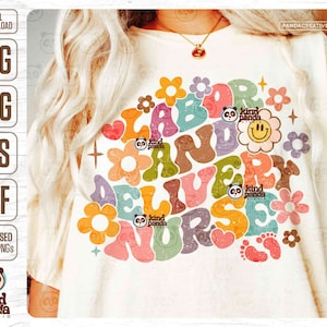 May include: A white t-shirt featuring a colourful graphic design that reads "Labor and Delivery Nurse" in a retro style with flowers and a smiley face. The graphic also includes the text "Kind Panda Studio".