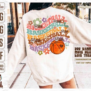 May include: A white sweatshirt with a colorful graphic design featuring the word "basketball" repeated in a circular pattern with flowers and a basketball. The text "You wanna more design like this?" is printed below the graphic.