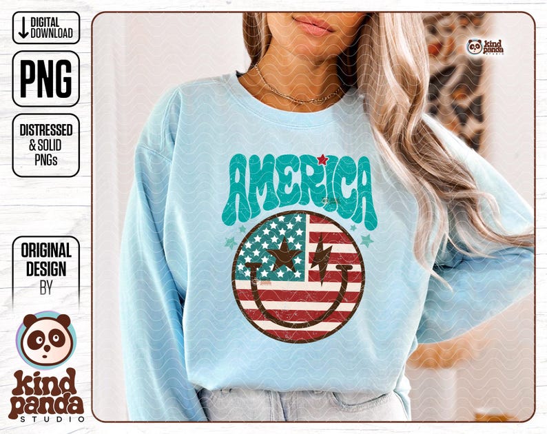 May include: A light blue sweatshirt with a graphic design of a smiley face with the American flag pattern. The text "AMERICA" is in a retro font above the smiley face.