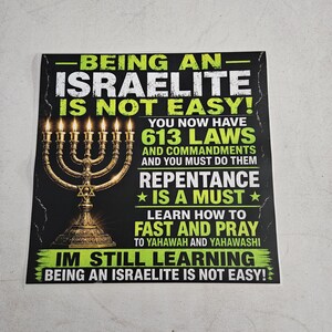 May include: A rectangular poster with a black background featuring a gold menorah on the left. The text reads: BEING AN ISRAELITE IS NOT EASY! YOU NOW HAVE 613 LAWS AND COMMANDMENTS AND YOU MUST DO THEM REPENTANCE IS A MUST LEARN HOW TO FAST AND PRAY.