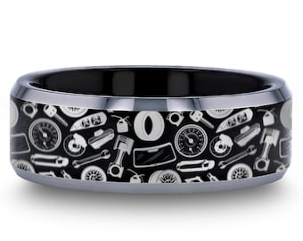 May include: A black tungsten carbide ring with a white pattern of car parts, including a tire, wrench, and speedometer.