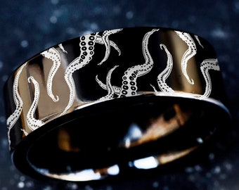 May include: A black ring with a white octopus design engraved on the band.