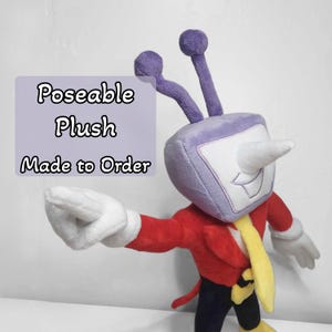 May include: A poseable plush toy with a television-shaped head, purple antennae, and a white nose. The plush is wearing a red jacket, yellow tie, and white gloves. The text "Poseable Plush Made to Order" is visible.