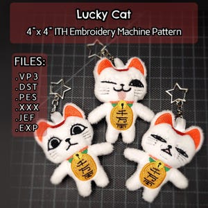 May include: Three white plush Lucky Cat keychains with orange accents, each holding a gold coin. The keychains are 4" x 4" and are an ITH (In The Hoop) embroidery machine pattern. The text "Lucky Cat" is at the top.