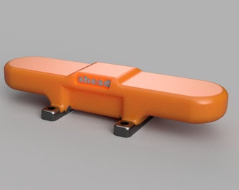 May include: Orange plastic device with the word "ahead" printed on it. The device has two black metal brackets on the bottom.