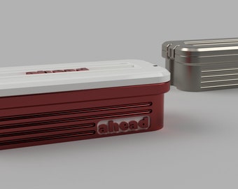 May include: Two rectangular storage containers, one red with a white lid and the other silver. The red container has the word "ahead" printed on the front. Both containers have a ribbed design.