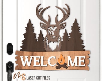May include: Wooden welcome sign with a deer head silhouette, pine trees, and a campfire graphic. The sign reads "WELCOME".