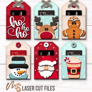 SVG Laser Cut Files for a bundle of 6 Christmas Gift Card Holders featuring cute Gift Tag shapes decorated with a Santa Claus, the text Ho Ho Ho, a Snowman, a Gingerbread Man, a Reindeer, and a Christmas Coffee Cup with spacers on the inside where you can insert your Gift Cards and money! Create festive Gift Card Holders, Money Holders, and gift Ornaments!