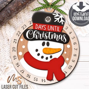 SVG Laser Cut Files for a Christmas Countdown Snowman Ornament featuring a cute snowman wearing a scarf and top hat adorned with a snowflake. His scarf covers a round turning wheel with 25 numbered days until Christmas, and his hat provides a window at the top to show how many days you have left! Turn the wheel each day until you reach the snowflake on Christmas morning!