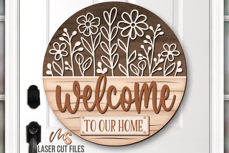 SVG Laser Cut Files for a round wood Floral Welcome Sign featuring a row of flowers filling the top half of the sign with a bottom panel that looks like a wood crate with the greeting Welcome To Our Home in decorative fonts. Make DIY Wildflower Door Hangers, Front Door Decor and Floral Porch Door Signs for spring and summer decor!
