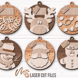 SVG Laser Cut Files for a bundle of 6 Christmas Gift Card Holders shaped like ornaments decorated with a Santa Claus, the text Ho Ho Ho, a Snowman, a Gingerbread Man, a Reindeer, and a string of Christmas lights with spacers on the inside where you can insert your Gift Cards and money, and an additional tag which says Merry Christmas or add your own custom name for personalization! Create festive Gift Card Holders, Money Holders, and gift Ornaments!