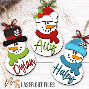 SVG Laser Cut Files for a bundle of three cute Snowman Ornaments wearing a santa hat, snowman hat, and winter beanie cap with scarfs, snowflakes, and an open space to add your own custom text and names. Perfect for making custom Christmas Ornaments, Christmas Gift Tags and Name Tags for the holidays!