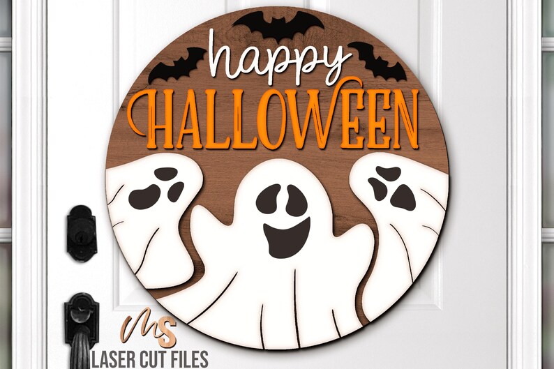 SVG files for a round wood Halloween Sign with three spooky ghosts peaking up from the bottom with the phrase Happy Halloween in decorative fonts and bats flying overhead. Perfect for making spooky Halloween Door Hangers, Ghost Signs, and Halloween decor this fall season!