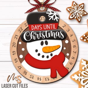 SVG Laser Cut Files for a Christmas Countdown Snowman Ornament featuring a cute snowman wearing a scarf and top hat adorned with a snowflake. His scarf covers a round turning wheel with 25 numbered days until Christmas, and his hat provides a window at the top to show how many days you have left! Turn the wheel each day until you reach the snowflake on Christmas morning!