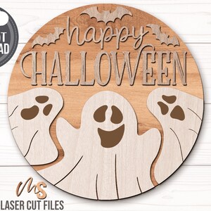 SVG files for a round wood Halloween Sign with three spooky ghosts peaking up from the bottom with the phrase Happy Halloween in decorative fonts and bats flying overhead. Perfect for making spooky Halloween Door Hangers, Ghost Signs, and Halloween decor this fall season!