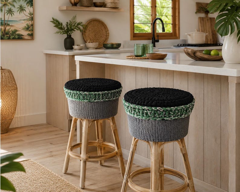 May include: Two bar stools with light-coloured wooden legs and circular seats. Each seat features a thick, textured crochet cover with a solid black top, a variegated green and white middle band, and a solid dark grey base section.