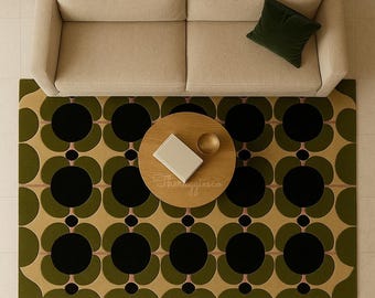 May include: Overhead view of a living room setup featuring a beige sofa, a round wooden coffee table with a book and bowl, and a green and black floral patterned rug. A dark green pillow rests on the sofa.