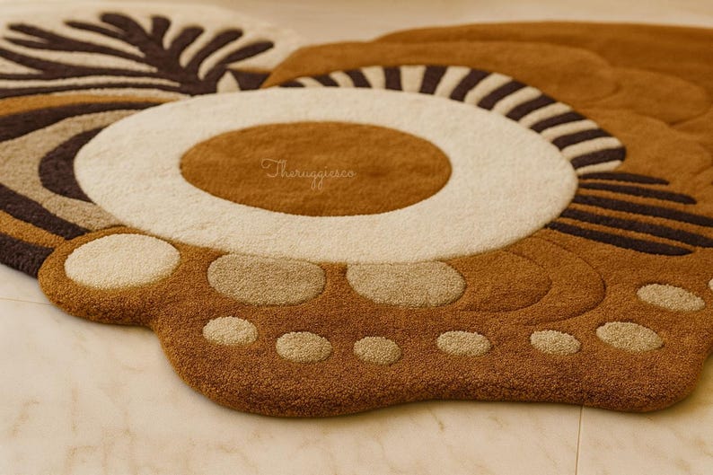 May include: Close-up of a brown, beige, and white rug with a paw print design. The rug features a circular center with a white border and a brown center. The paw has beige circles and a brown background. The rug is made of a soft, textured material.