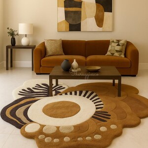 May include: A modern living room featuring a large, brown floral-shaped rug. The rug has a cream-colored center with brown and black accents. A brown sofa, coffee table, and abstract art piece complete the room's decor.