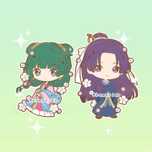 May include: Two cartoon characters in traditional Asian attire. One has green hair and wears a pink and blue outfit, the other has purple hair and wears a blue outfit. Both are decorated with flowers and have large eyes.