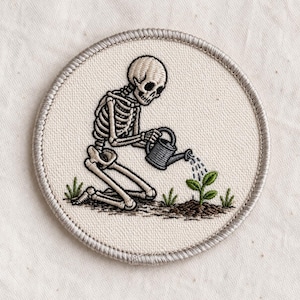 May include: A set of three ceramic mugs with a speckled, matte finish. The mugs are in shades of cream, light gray, and dark gray. Each mug has a simple, minimalist design, perfect for coffee or tea.