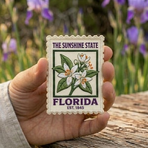 May include: A set of three ceramic mugs with a speckled, matte finish. The mugs are in cream, light grey, and dark grey. Each mug has a simple, minimalist design, ideal for coffee or tea.