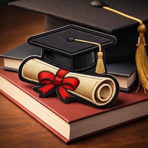 May include: An embroidered patch depicting a black mortarboard with a gold tassel and a scroll tied with a red bow. The patch is on a stack of books, with a graduation cap in the background.