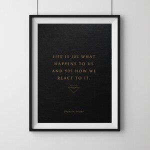 Puede incluir: Un póster de cita motivacional en blanco y negro con texto dorado que dice "La vida es un 10% lo que nos sucede y un 90% cómo reaccionamos." La cita se atribuye a Charles R. Swindol.