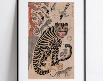 May include: A framed print featuring a large central tiger with black stripes on a tan background, surrounded by smaller tigers, birds, and a red tree. The artwork includes vertical columns of black East Asian characters on the right and left sides.