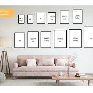 May include: A diagram showing different sizes of picture frames, with measurements in inches and centimeters. The frames are shown on a white wall, with a couch and a lamp in the foreground.