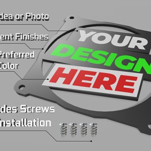 May include: A black metal fan grill with the text "YOUR DESIGN HERE" in white, green, and red. The grill includes screws for installation.