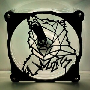 May include: Black and white geometric design of a bear's head with an open mouth, printed on a clear plastic fan.