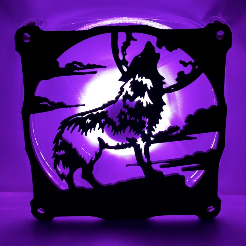 May include: A black silhouette of a wolf howling at the moon, cut out of a computer fan. The fan is lit with a purple light.