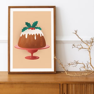 May include: A Christmas pudding with white icing and a sprig of holly on top, sitting on a pink pedestal cake stand against a light peach background.