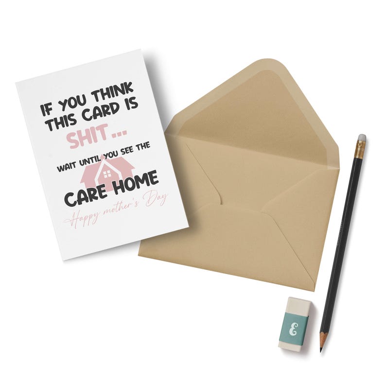 A rude and funny Mother's Day card featuring a pink house graphic and a sarcastic care home joke, placed next to a luxury brown kraft envelope, a pencil, and an eraser.