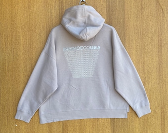 May include: A light gray hoodie with a large graphic on the back that says "DR SHOE CO USA" repeated in a pattern.