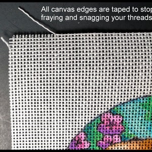 May include: Close-up of a white needlepoint canvas with a colorful floral design. The canvas edges are taped to prevent fraying, with the text "All canvas edges are taped to stop fraying and snagging your threads."
