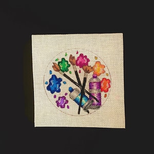 May include: A white canvas with a colorful paint splatter design. The design includes paintbrushes, paint tubes, and paint splatters in various colors, including blue, green, red, orange, and purple.
