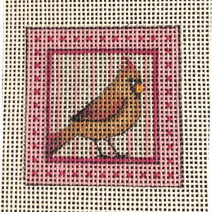 May include: Needlepoint canvas featuring a detailed bird design. The bird is depicted in shades of brown, yellow, and orange, set against a pink square border with a dotted pattern. The background is a white canvas with a grid pattern.