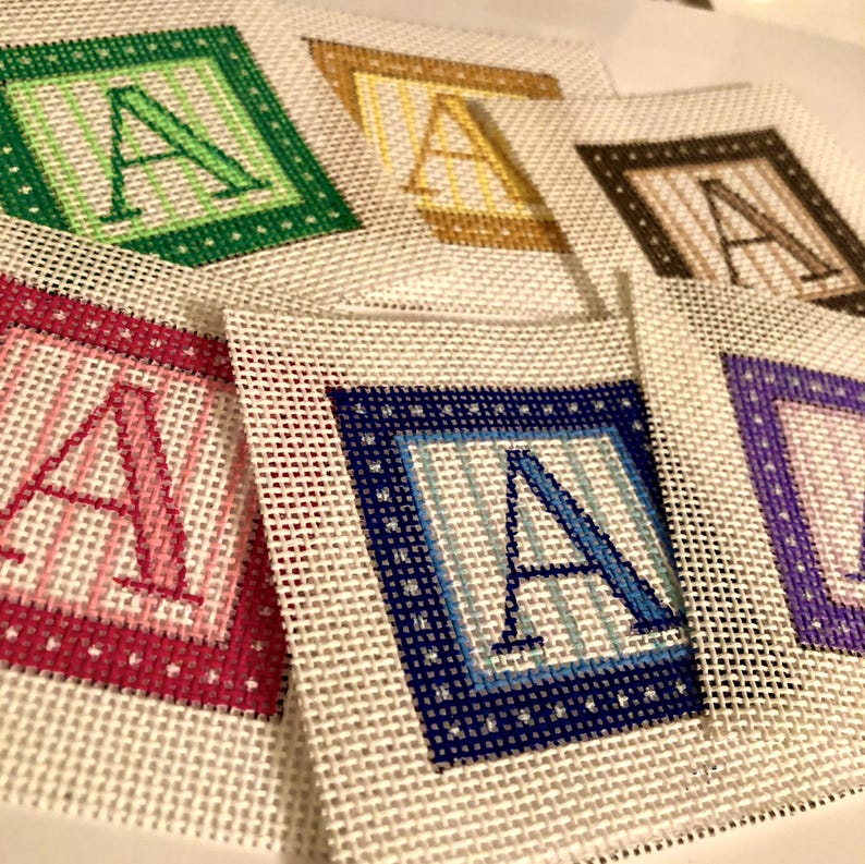 Mini custom bag charm with initial needlepoint, hand-painted for a personal touch. A great gift idea, this 2" piece is the perfect size for a vibrant ornament, bag accessory, or tabletop decoration.