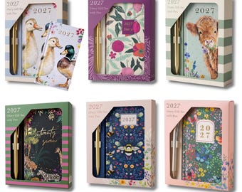 May include: Six 2027 diary gift sets with pens, each in a rectangular box. Designs include ducks, floral patterns, a highland cow, jungle animals, bees, and butterflies. Each set features a 2027 diary and a matching pen in a windowed box.