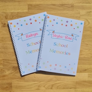 Two examples of personalised school memory books with names in pink