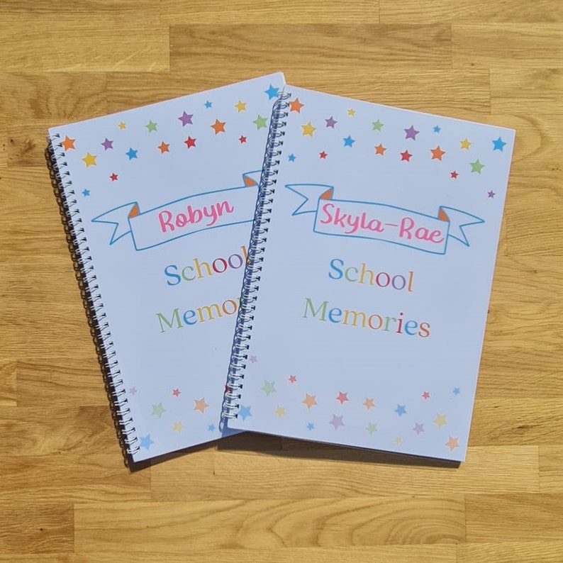 Two examples of personalised school memory books with names in pink