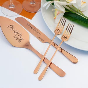 May include: Rose gold wedding cake knife and two forks with the words "Mr. & Mrs." and the date "July 19, 2023" engraved on them. The knife also has the words "Always & Forever" engraved on it.