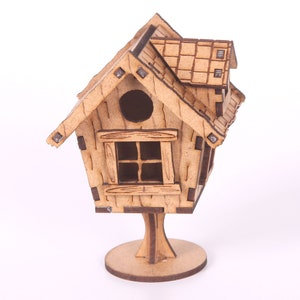 May include: A wooden birdhouse with a brown roof, a small window, and a round opening. The birdhouse is on a wooden stand with a round base.