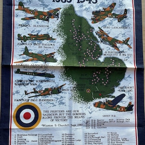 May include: A navy blue tea towel featuring a map of England with illustrations of World War II-era aircraft. The towel includes text about the Royal Air Force Bomber Command, with a list of airfields and the text "The Fighters are our Salvation, but the Bombers Alone Provide the Means of Victory."