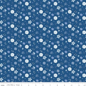 May include: A fabric with a repeating floral pattern. The design features small white and light blue flowers and leaves on a dark blue background. The fabric is measured in inches.
