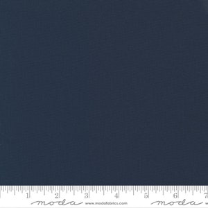 May include: A solid dark blue fabric swatch with a ruler showing 7 inches. The ruler has the word "moda" printed on it twice, with the website address "www.modafabrics.com" printed in the center.