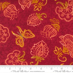 May include: A close-up of a red fabric with a floral pattern. The design features stylized flowers and a butterfly in shades of yellow and orange. The fabric has a subtle, textured appearance.
